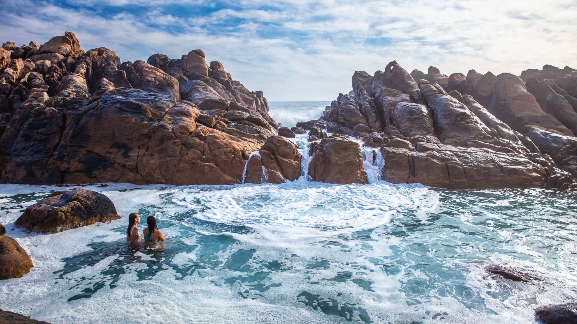 Two women having a dip in Injidup Natural Spa, Yallingup, Western Australia